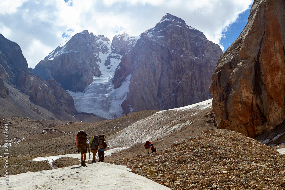 group of mountaineers climbs to top of now-capped mountain, Fann, Pamir Alay, Tajikistan