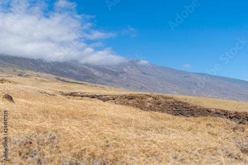 Landscape along Piilani Highway on the island of Maui  Hawaii  USA. Also known as the back road to Hana  the highway leads along Mt. Haleakala s southern flank. Beautiful dry grass and mountain.