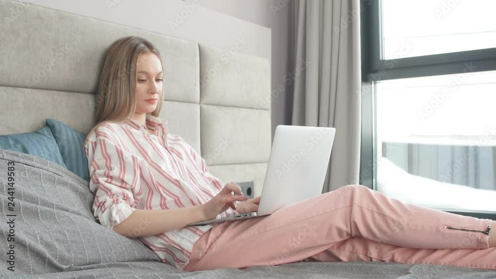 young girl uses laptop early morning in bed. young girl uses laptop early morning in bed.