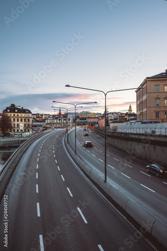 Cityscape view on highway right in the old town city center  classic Europe architecture. Cars on the road