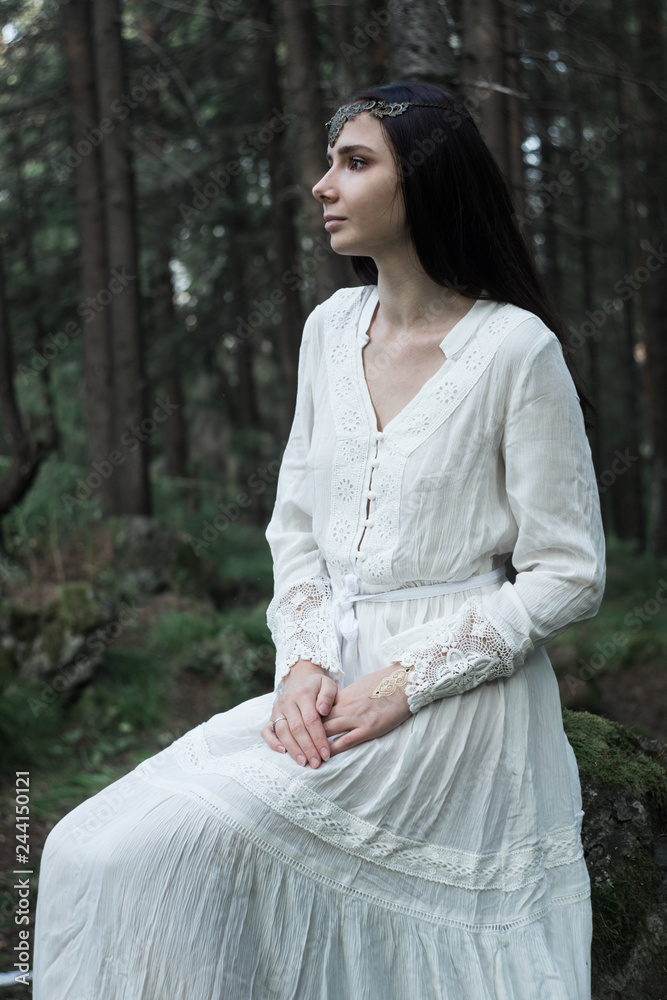 beautiful young sexy girl walks and rests in a fairy forest, she has a white gentle dress and a tiara in her hair, she looks like an unearthly nymph, light and graceful, trees are juicy mint-colored beautiful young sexy girl walks and rests in a fairy forest, she has a white gentle dress and a tiara in her hair, she looks like an unearthly nymph, light and graceful, trees are juicy mint-colored