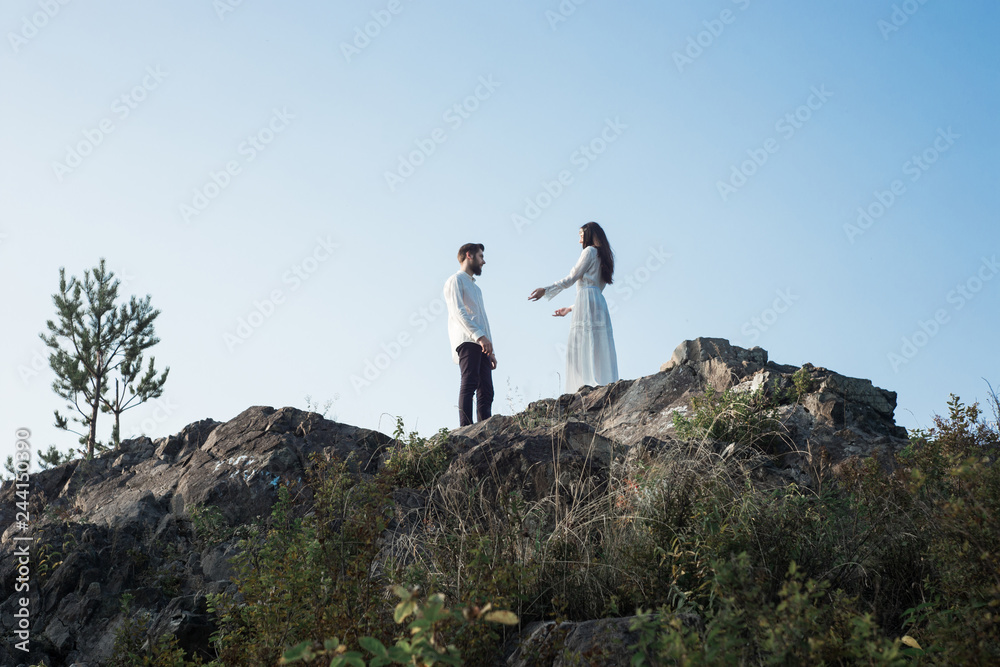 Beautiful couple in love walks in the mountains, against the backdrop of rocks, in the rays of the setting sun. man and woman love each other, they are gentle and happy, a love story and a wedding day Beautiful couple in love walks in the mountains, against the backdrop of rocks, in the rays of the setting sun. man and woman love each other, they are gentle and happy, a love story and a wedding day
