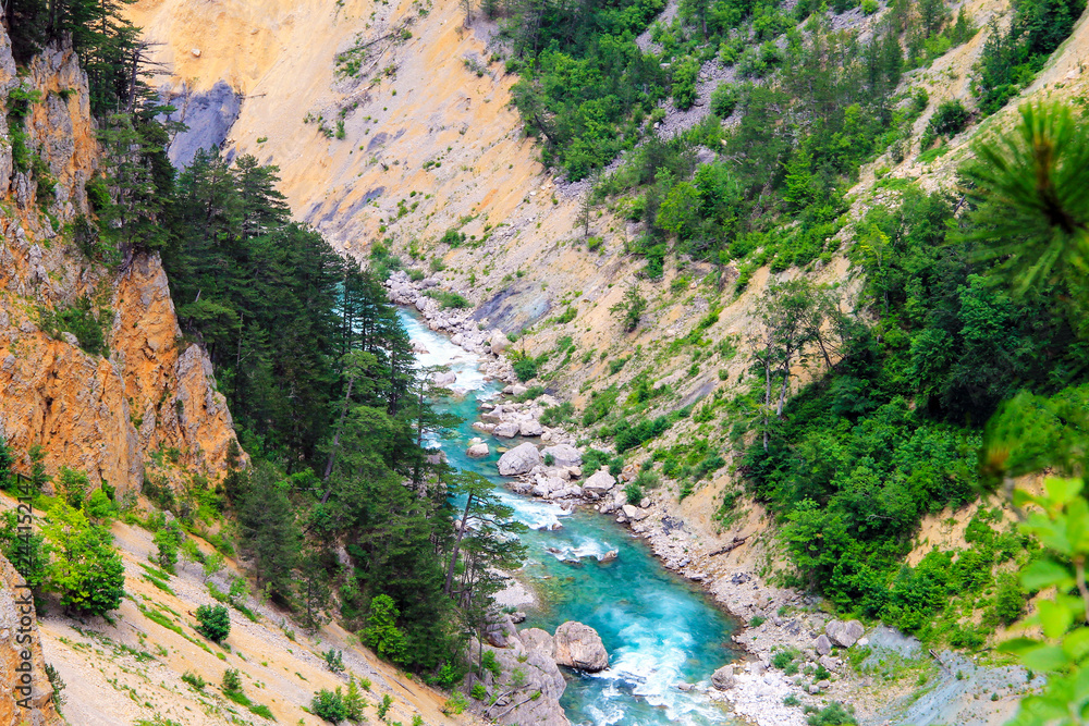 Montenegro mountains landscape . The blue river flows in a deep canyon among the high mountains covered with green forest in Montenegro. Montenegro mountains landscape . The blue river flows in a deep canyon among the high mountains covered with green forest in Montenegro.