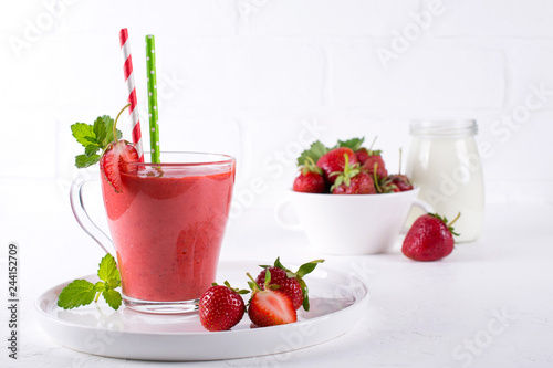 Strawberry smoothie or milkshake in glass cup. Healthy food for breakfast and snack