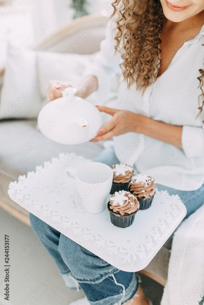Portrait of a young girl with a smile and cupcakes. Photo shoot in the interior light Studio. Portrait of a young girl with a smile and cupcakes. Photo shoot in the interior light Studio.