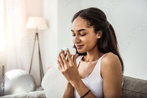 Vászonkép Kind international woman smelling cream for face