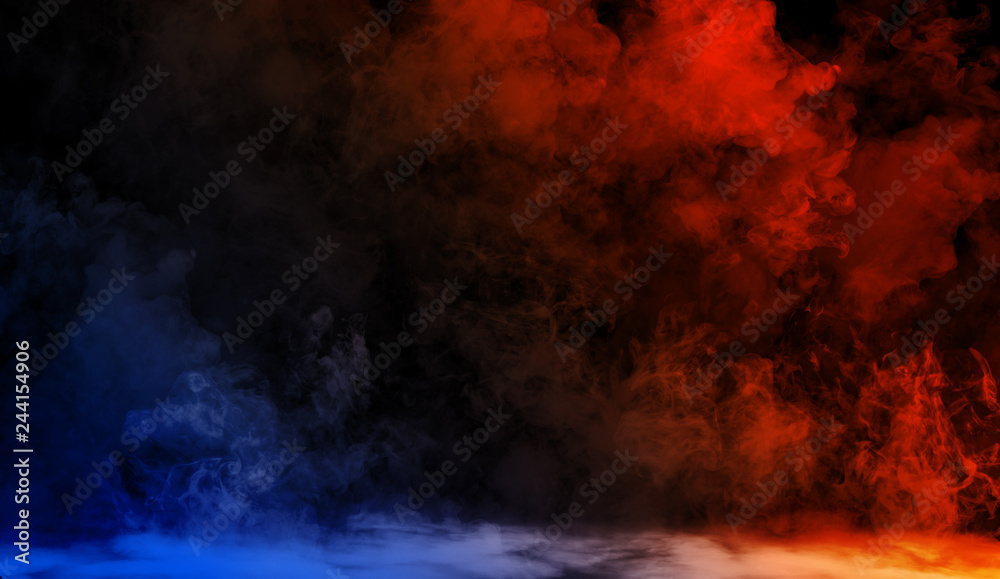 Fototapeta premium Abstract blue vs orange smoke steam moves on a black background . The concept of aromatherapy