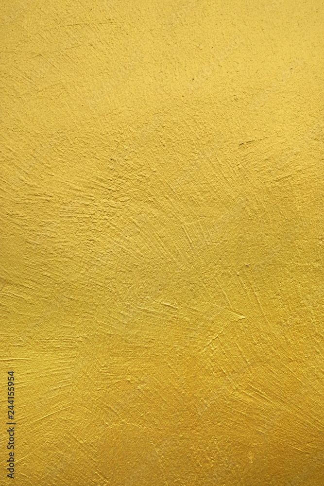 wall painted with gold color. textured background. wall painted with gold color. textured background.