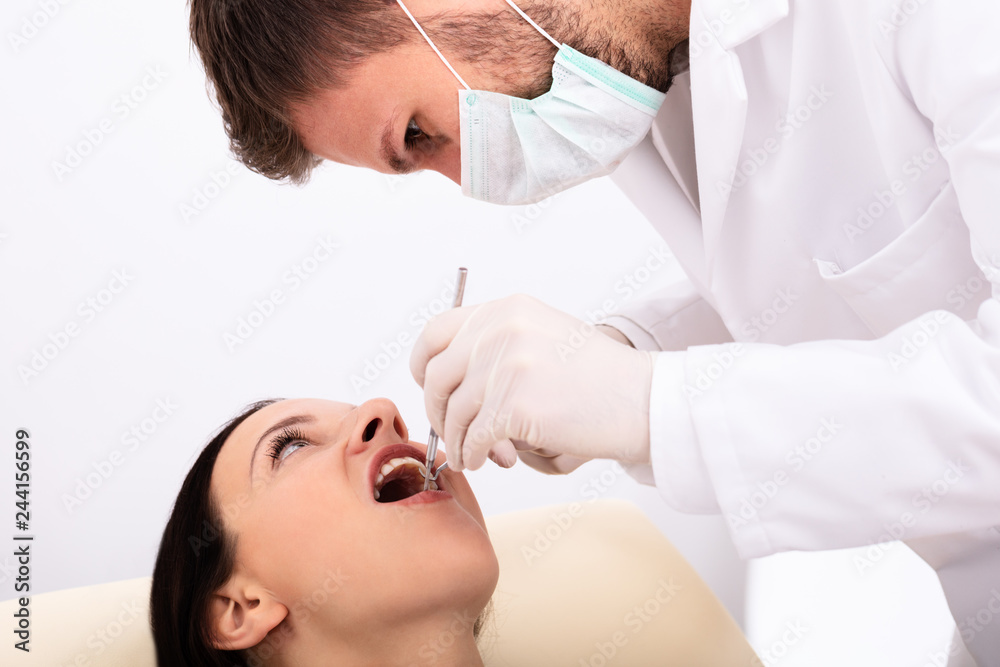 Dentist Examining Woman's Teeth