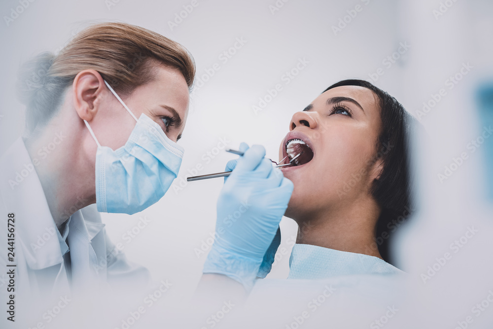 Professional medical worker treating her international patient