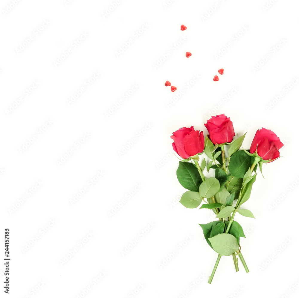 Valentine's day composition background . Bouquet of a beautiful red roses and red hearts on white background. top view. Copy space