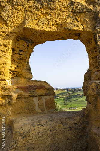 Sicilian landscape framed by the ruins of early medieval necropolis at Valle dei Templi (Valley of the Temples), Agrigento, Sicily, Italy