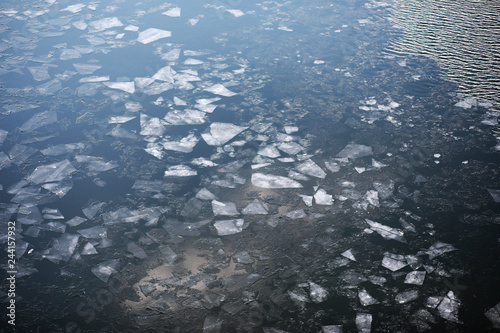 Drifting on the river. Fragments of ice float on river.