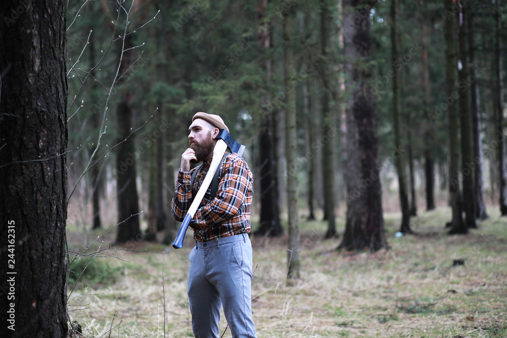 A bearded lumberjack with a large ax A bearded lumberjack with a large ax