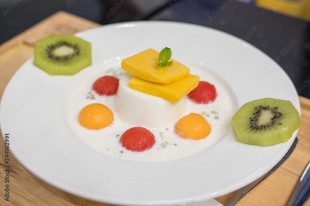 Panna Cotta with Watermelon, Melon, Mango and Kiwi served on plate Panna Cotta with Watermelon, Melon, Mango and Kiwi served on plate