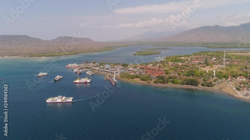 Aerial view ferry port gilimanuk with ferry boats, vehicles. Ferries transport vehicles and passengers in port. Port for departure from Bali to the island of Java. photo