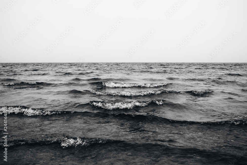 waves in the sea black and white photo - obrazy, fototapety, plakaty 