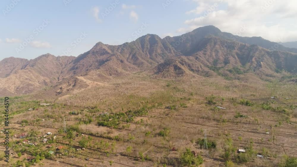 aerial view agricultural land and mountains in countryside. mountain range with high cliffs mountain slopes covered with vegetation bali, indonesia