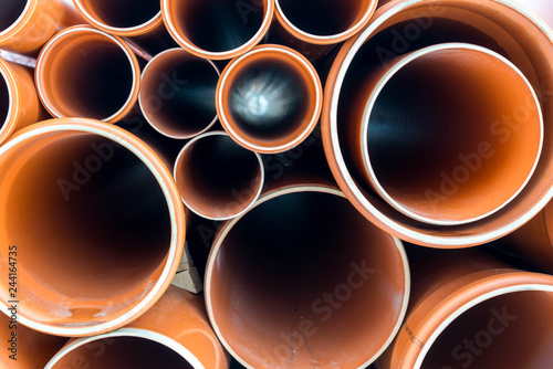 Orange sewage pipes close up shot for background.