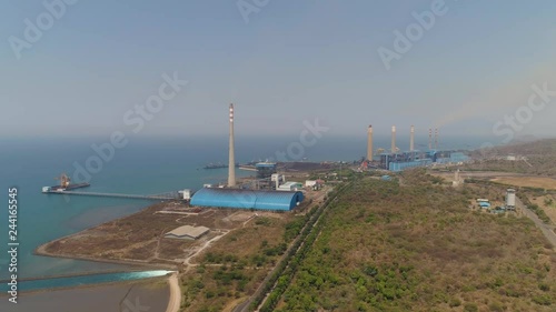 power station by sea with smoking pipes, paiton java, indonesia. aerial view power plant in asia. photo