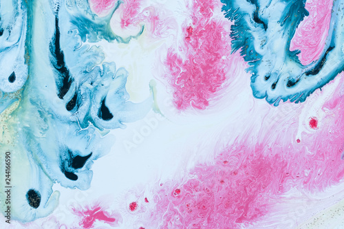 Abstract colorful background. Drawing with acrylic paints on water. Texture play of paint