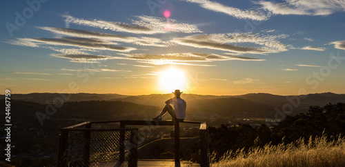 Foto Young man is looking at the sunset, New South Wales, Australia