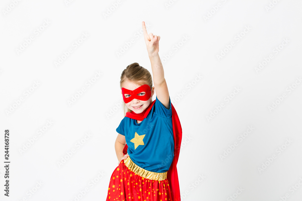beautiful girl with red mask and supergirl outfit posing in front of white background