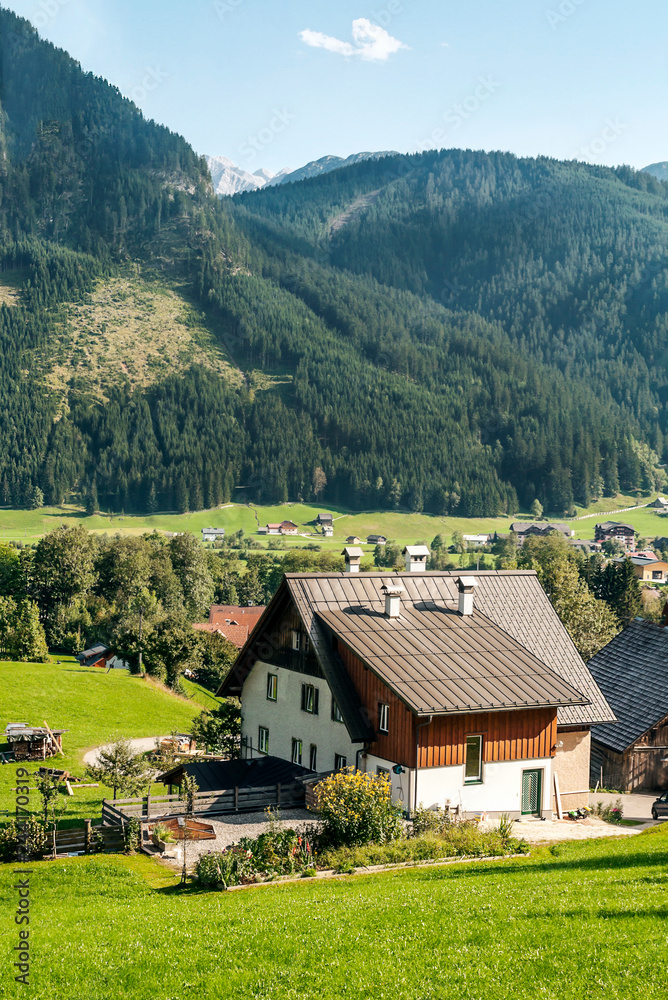 Village of Gosau with its wooden houses in the Alps of Austria on a sunny day.