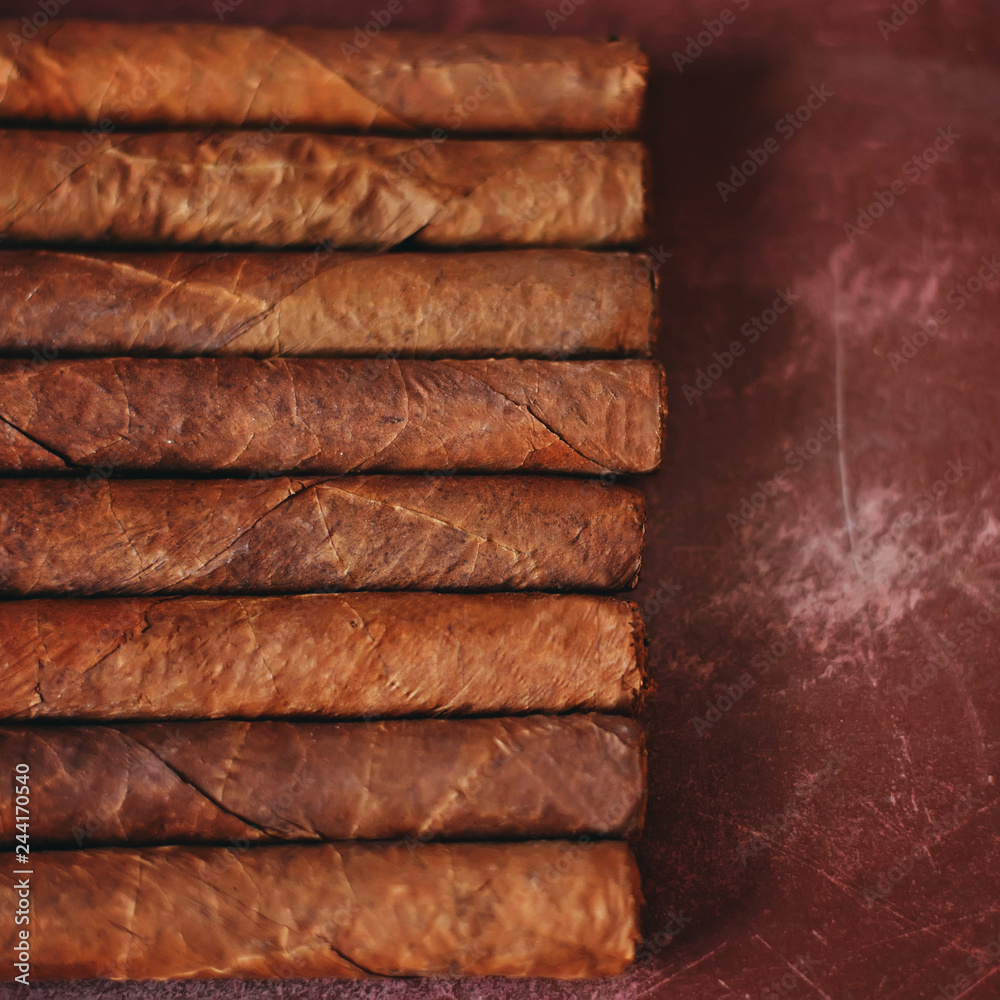 Luxury Cuban cigars on the wooden table. Luxury Cuban cigars on the wooden table.