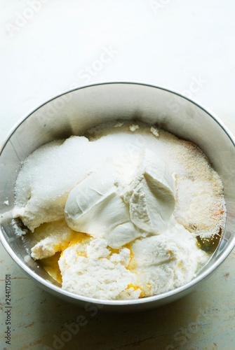 whipped cream topped dessert ingredients in metal mixing bowl