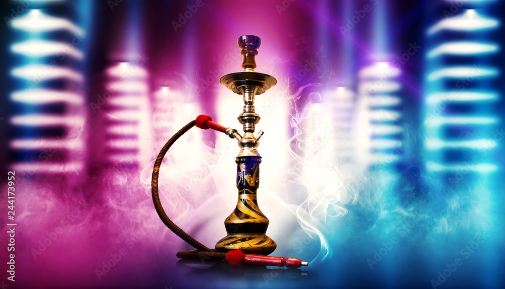 Hookah smoking on the background of an empty dark room, a corridor with neon glowing piles. Spotlight, laser beams, smoke. Hookah smoking on the background of an empty dark room, a corridor with neon glowing piles. Spotlight, laser beams, smoke.