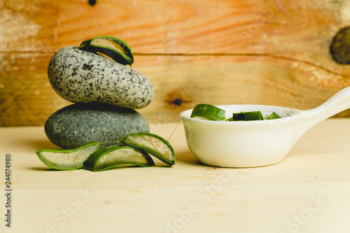 slices of fresh aloe on a calm, rustic, wooden background