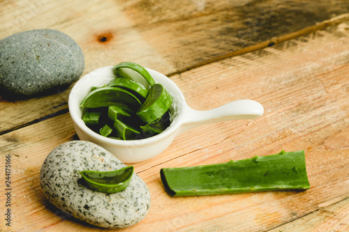 slices of fresh aloe on a calm, rustic, wooden background