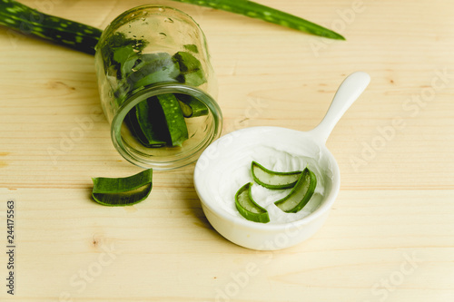 slices of fresh aloe on a calm, rustic, wooden background