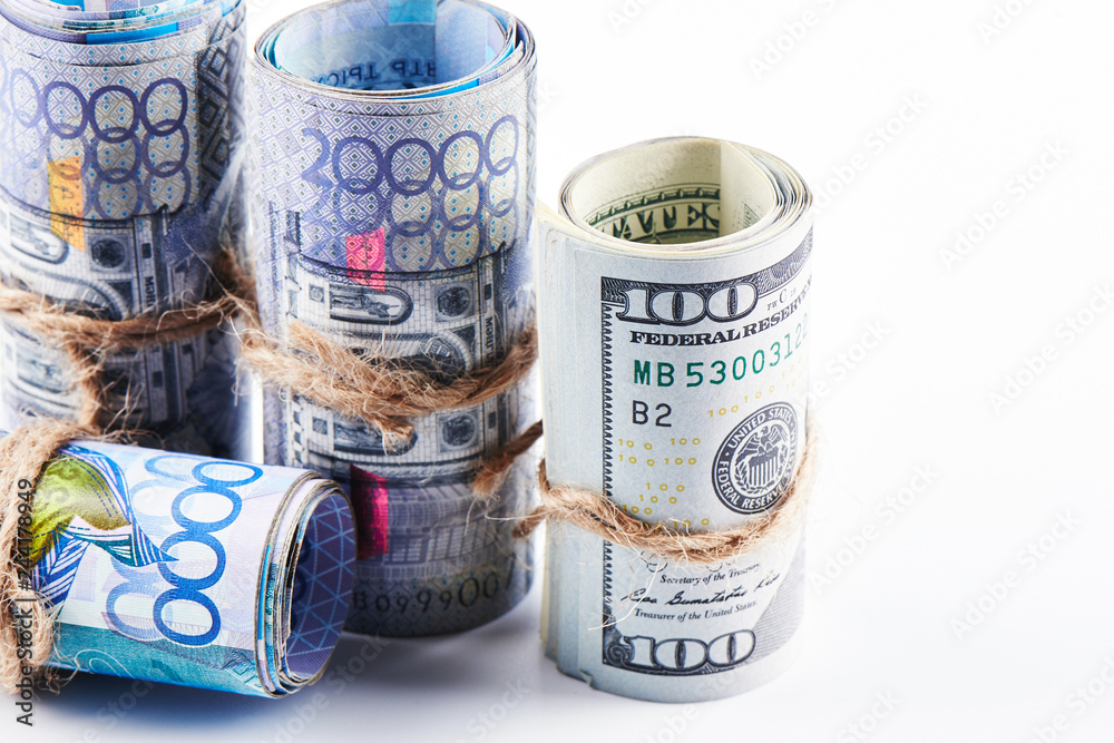 Dollars and tenge. American and Kazakh money on a white background. Isolated. Dollars and tenge. American and Kazakh money on a white background. Isolated.