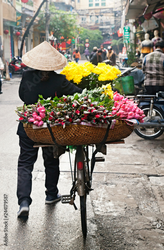 Woman selling flowers on the street in Hanoi, Vietnam