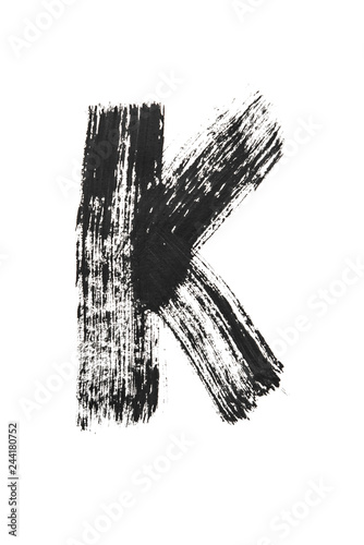 The English alphabet, the letter "K" is written in black paint on a white isolated background