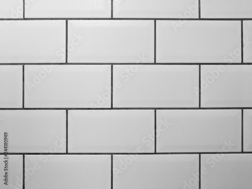 White metro tiles with grey grout. White rectangle tiled background