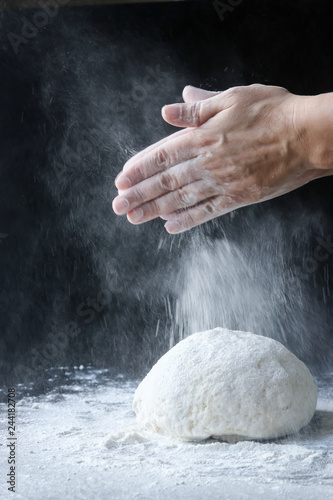 making dough with flour by female hands