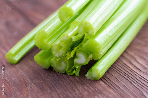 fresh celery, celery stalks close up on wooden background