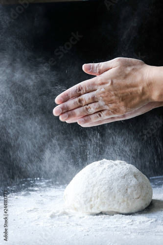 making dough with flour by female hands