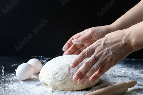 making dough with flour by female hands