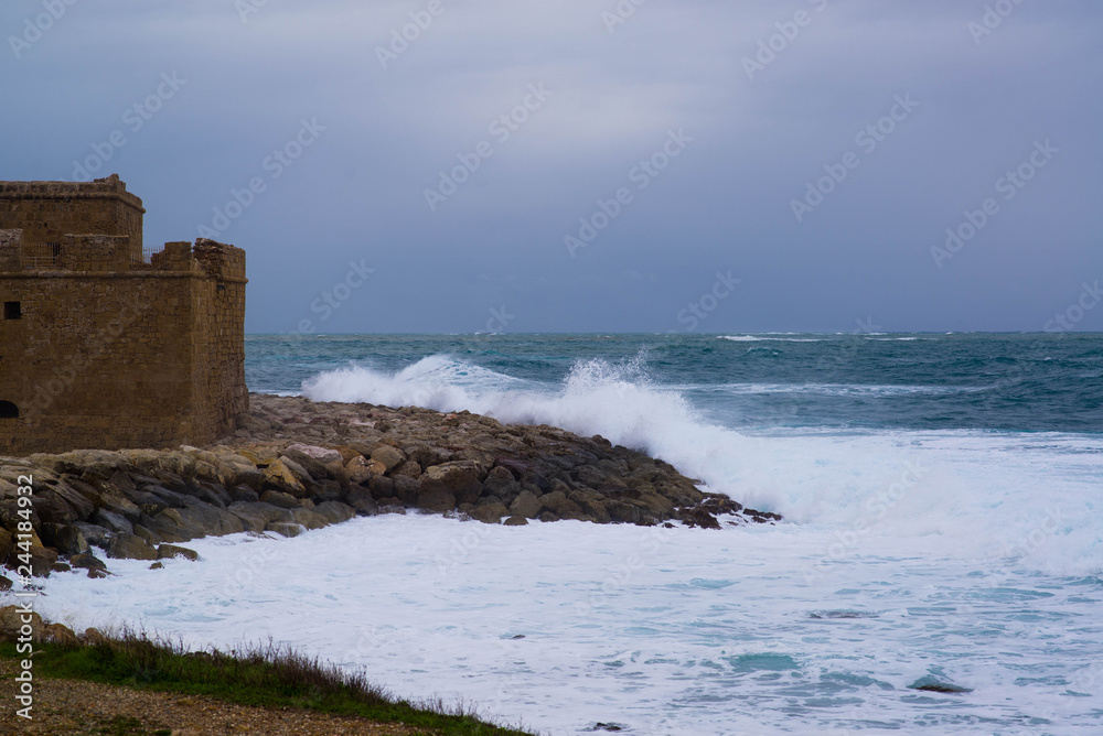 Old fort during a storm on the sea and big waves