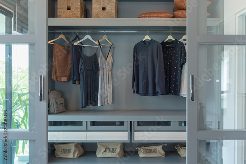 modern closet with clothes hanging