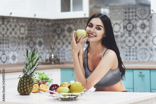 Beautiful woman with healthy food fruit in the kitchen