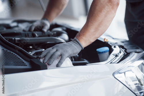 Auto mechanic working in garage. Repair service