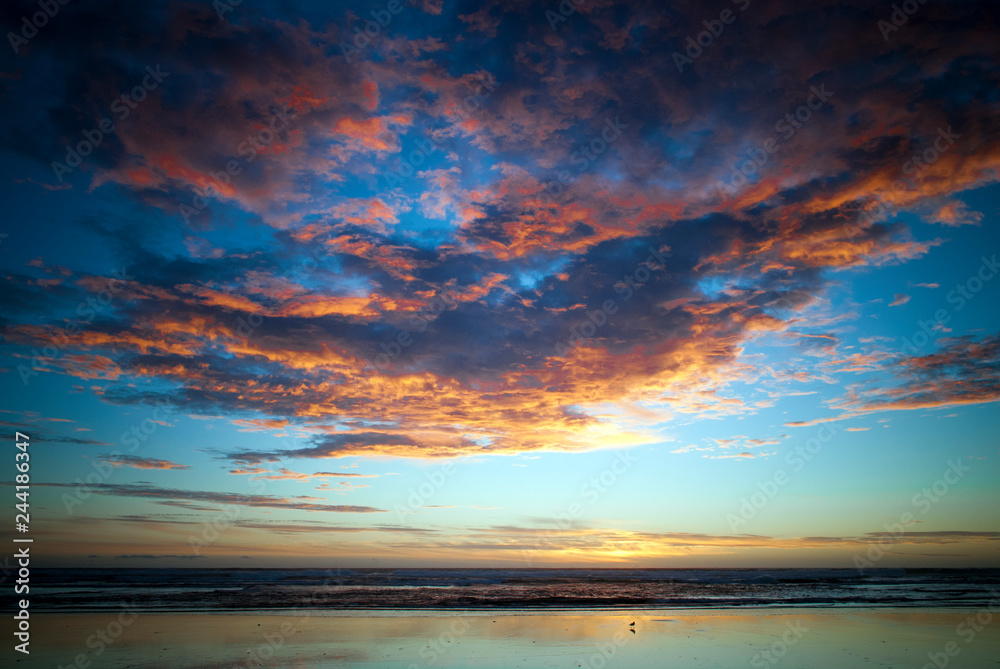 sunset at the beach with colourful overcast sky sunset at the beach with colourful overcast sky