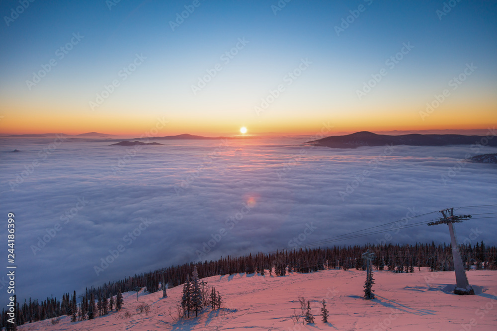 Beautiful Sunrise at Ski Resort, Italian Alps, Italy. sunrise, sunset. mountain valley. above the clouds. stock photo footage. back light