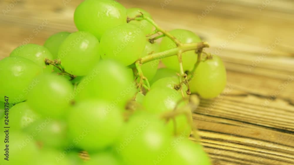 Green grape on wood kitchen surface. Fresh fruits 4k footage. Green grape on wood kitchen surface. Fresh fruits 4k footage.