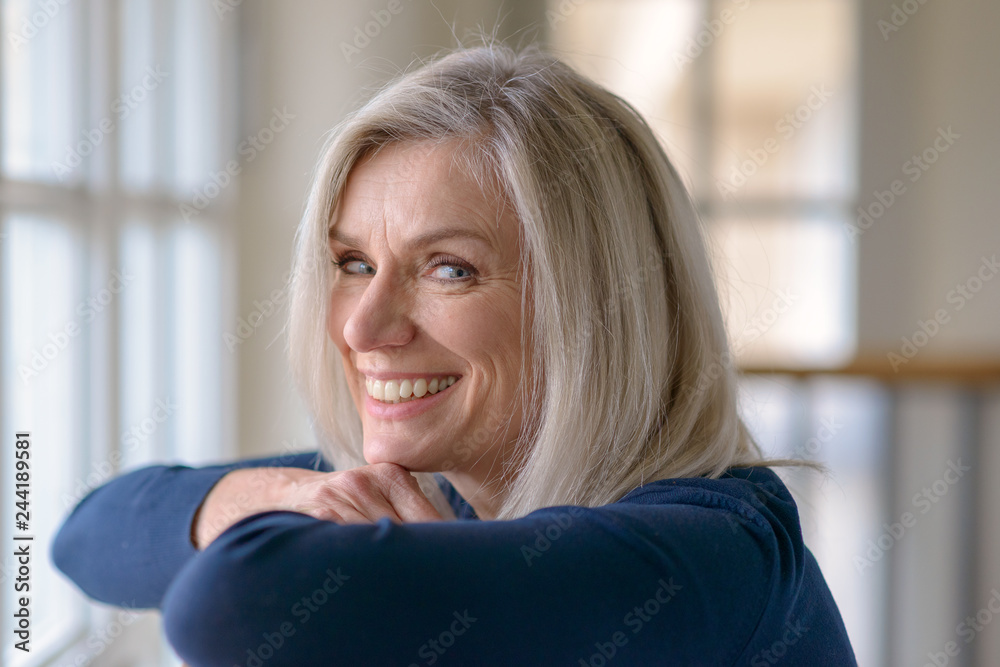 Happy blond woman with a vivacious friendly smile Happy blond woman with a vivacious friendly smile
